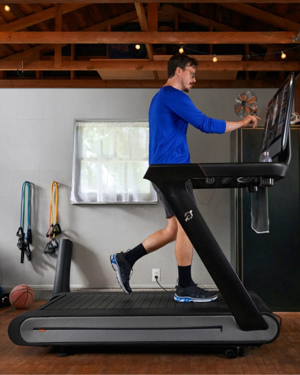 Peloton member using the tread plus in his home