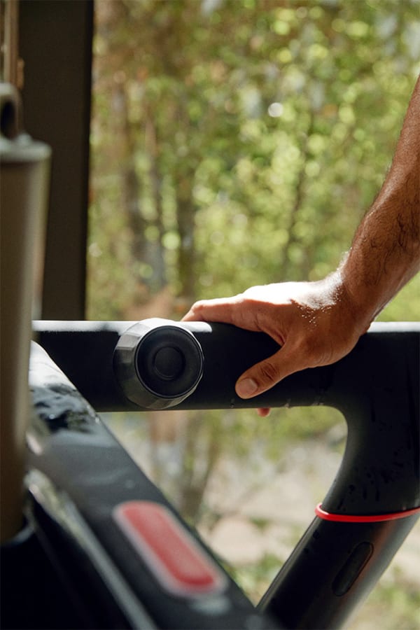 Peloton member using the tread in her home