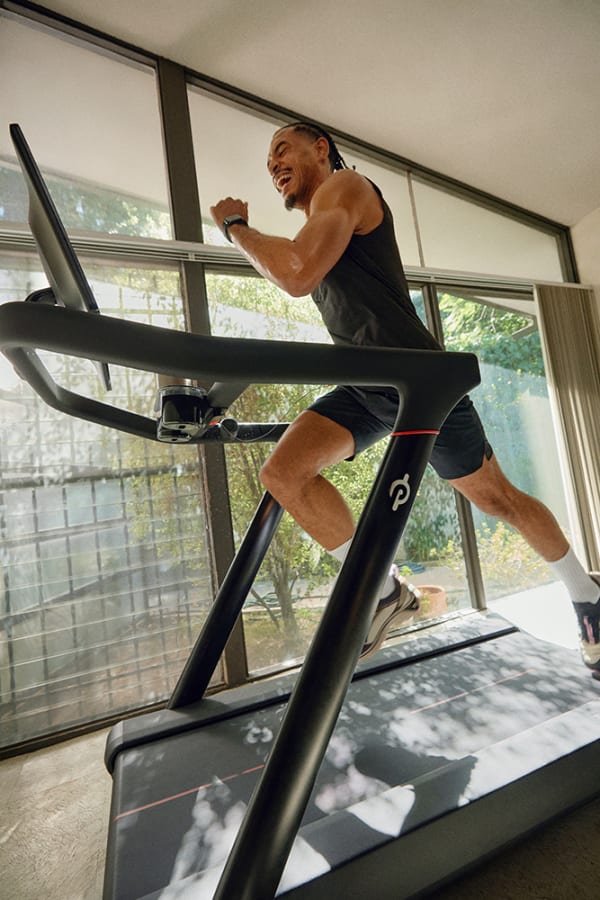 Peloton member using the tread to take a strength class